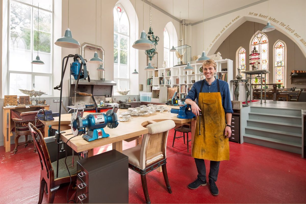 Old Meeting House silversmith&rsquo;s workshop within a converted chapel, beneath tall arched windows and stained glass